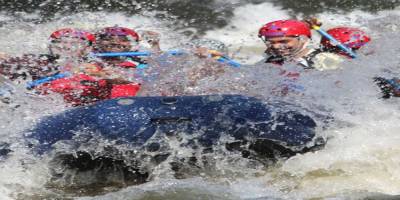 Paddle Raft crashing through white water on the Pigeon River